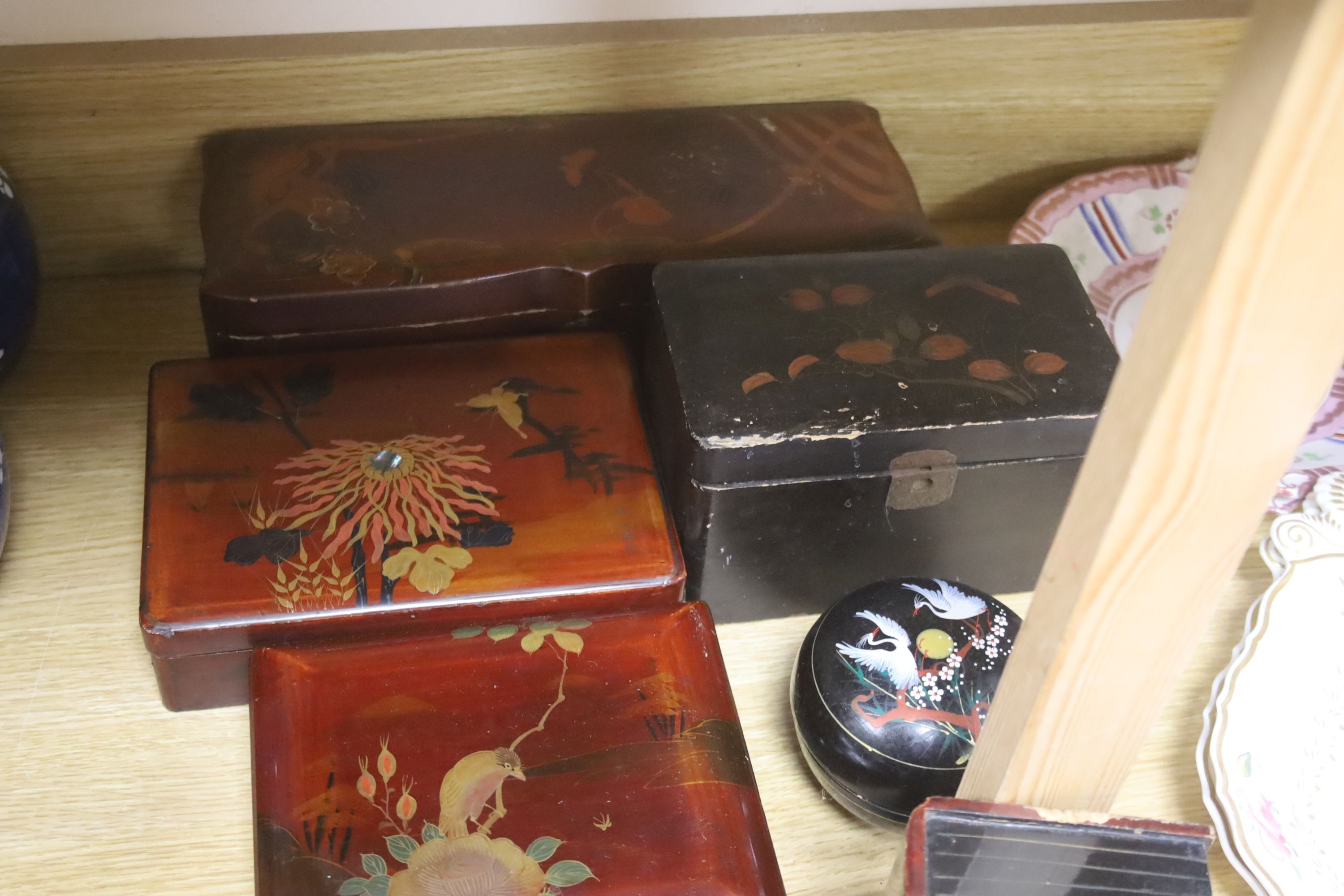 A group of Chinese or Japanese lacquer boxes and a wood stand